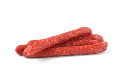 Photo of Many thin dry cured sausages isolated on white