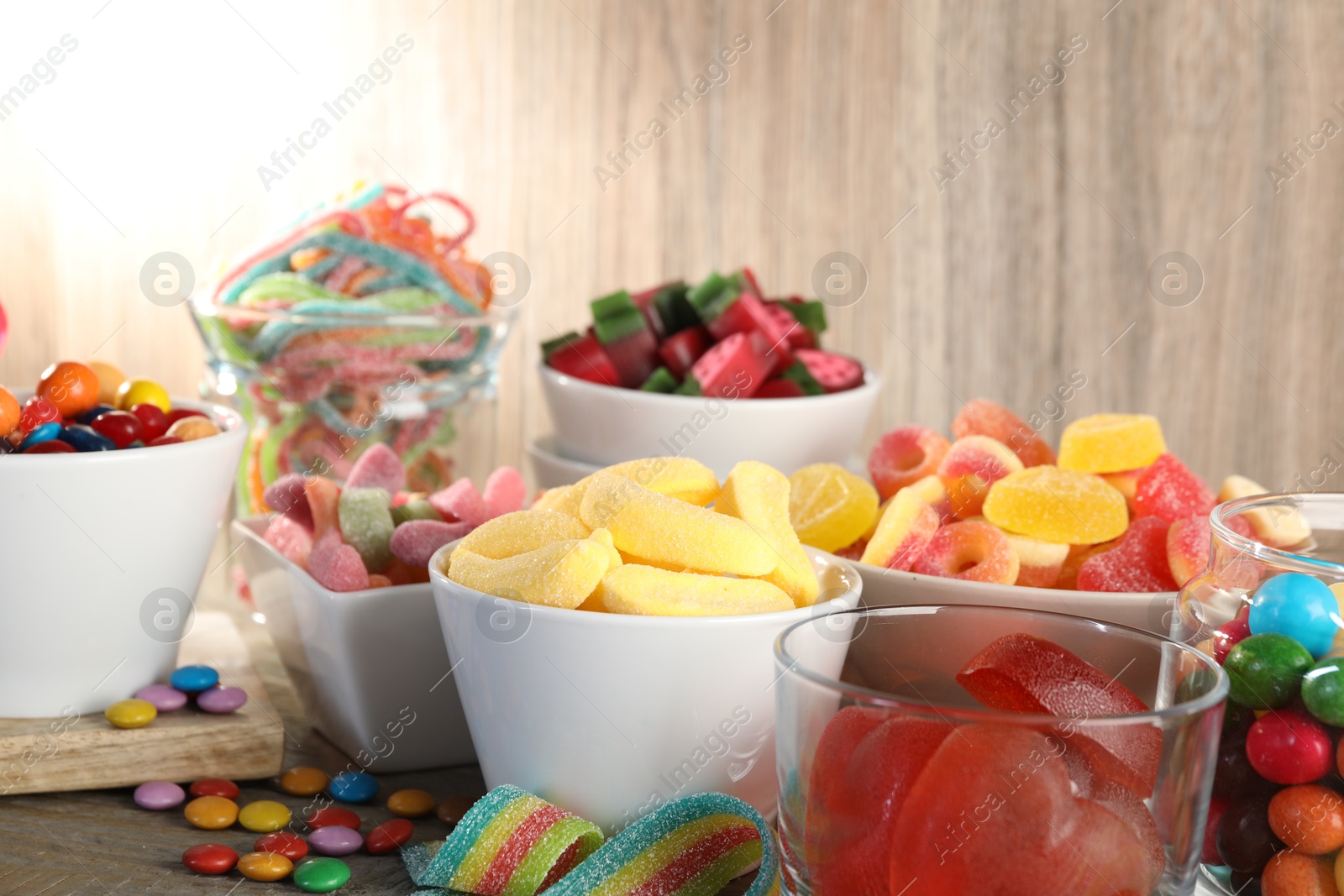 Photo of Candy bar. Many different sweets on wooden table, closeup