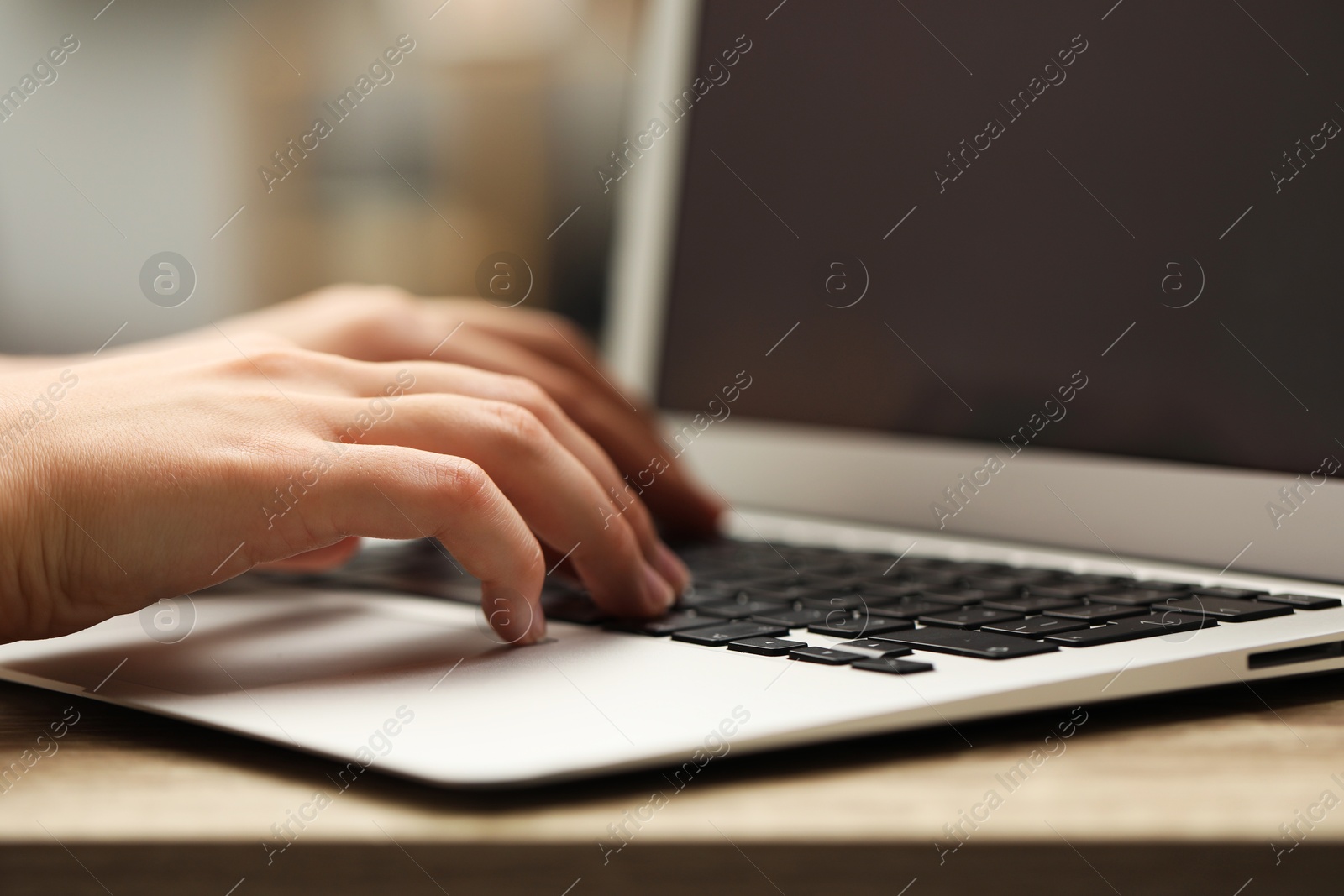 Photo of Businessman using laptop at table, closeup. Modern technology