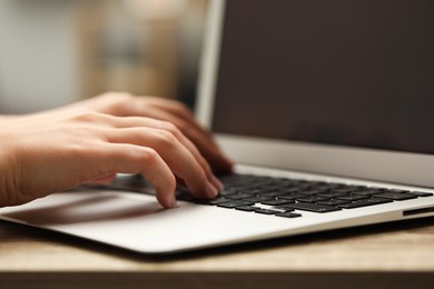 Photo of Businessman using laptop at table, closeup. Modern technology