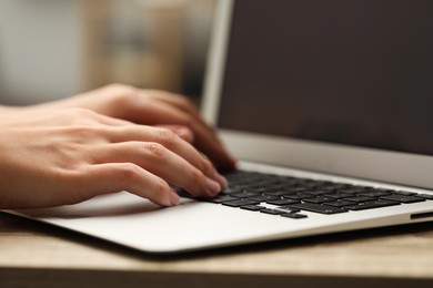 Photo of Businessman using laptop at table, closeup. Modern technology