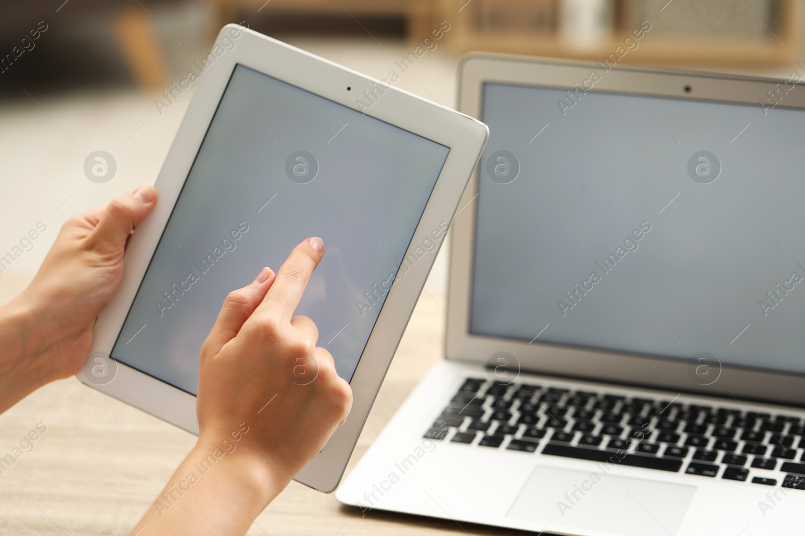 Photo of Businessman using tablet at table, closeup. Modern technology