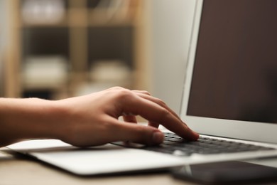 Photo of Businessman using laptop at table, closeup. Modern technology