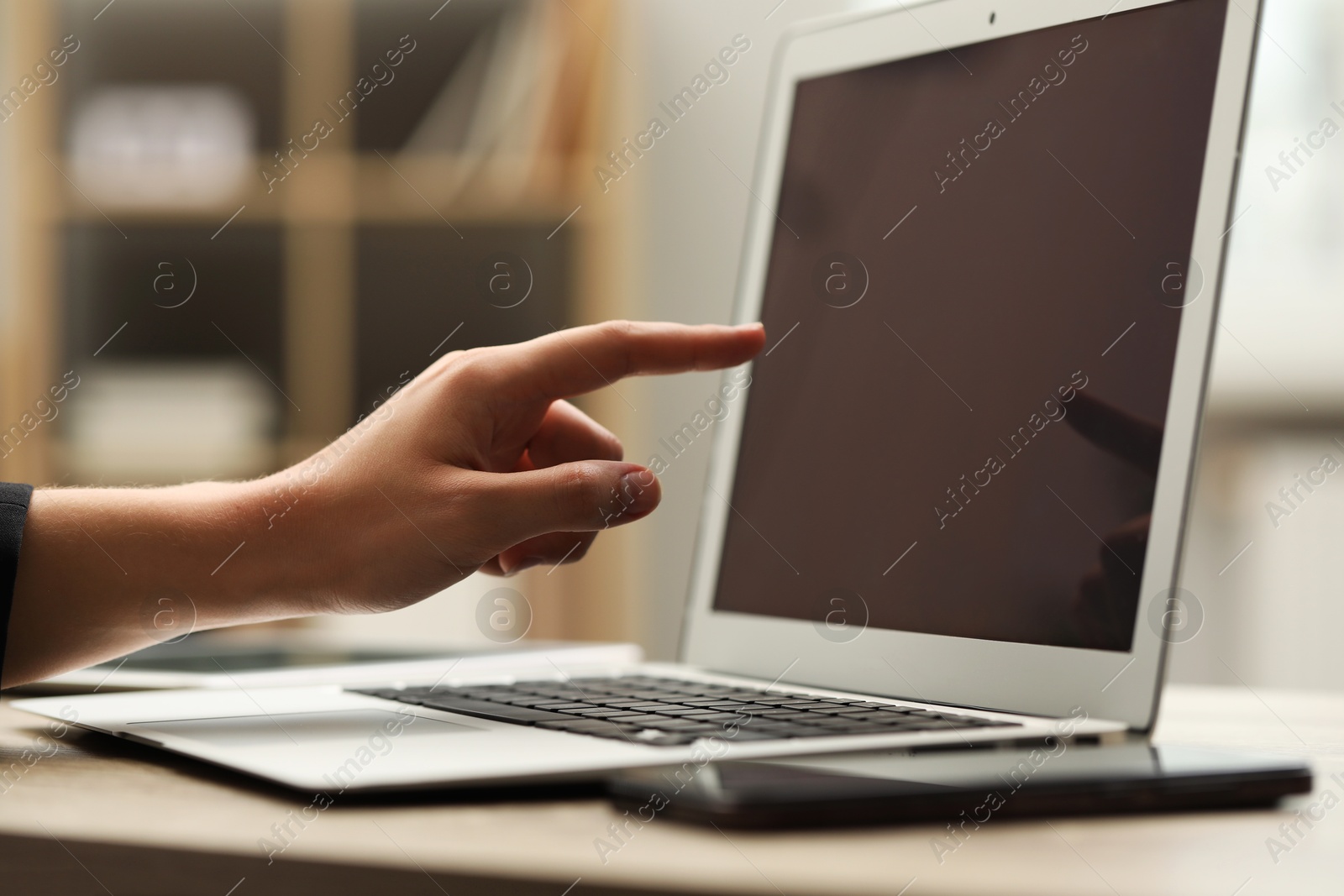 Photo of Businessman using laptop at table, closeup. Modern technology