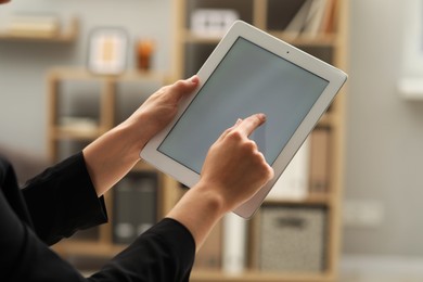 Photo of Businessman using tablet in office, closeup. Modern technology