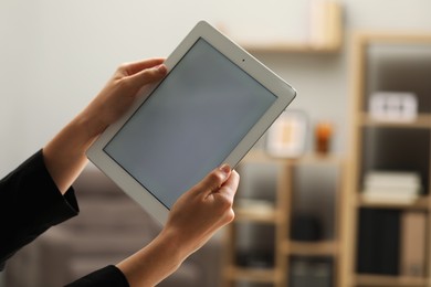 Photo of Businessman using tablet in office, closeup. Modern technology