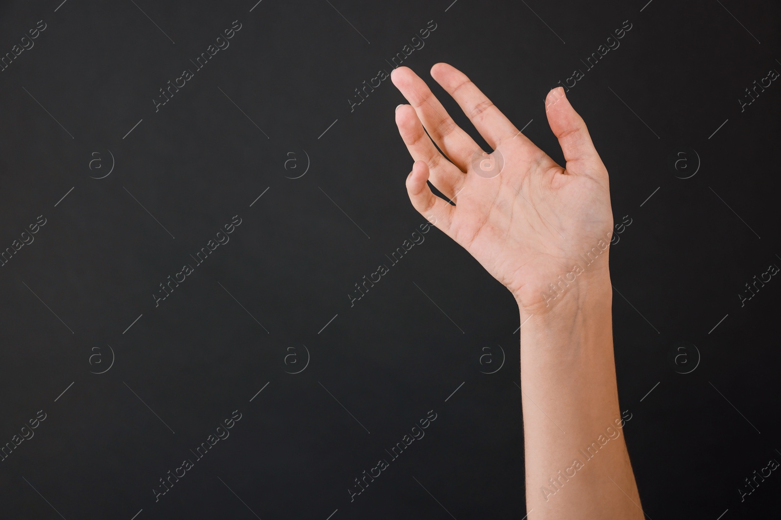 Photo of Woman with visible hand veins on black background, closeup. Space for text