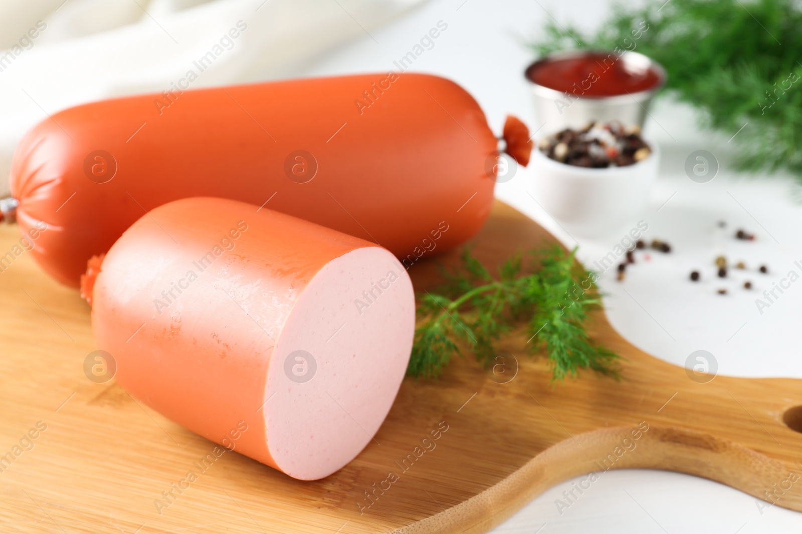 Photo of Tasty boiled sausages and spices on white table, closeup