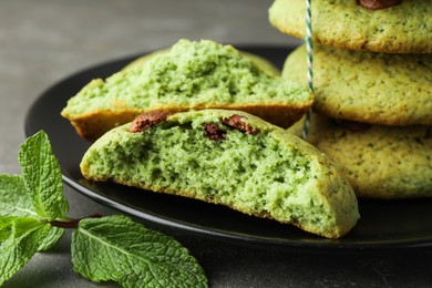 Photo of Delicious mint chocolate chip cookies on grey table, closeup