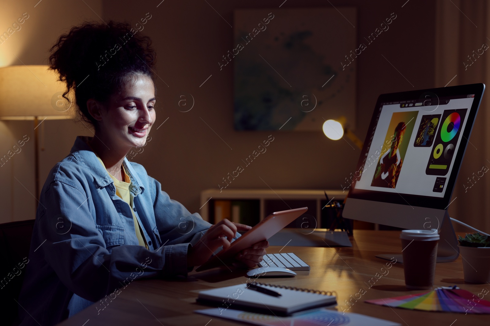 Photo of Designer working on tablet indoors at night