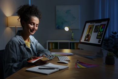 Photo of Designer with color palette working indoors at night