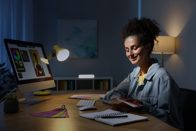 Photo of Designer with color palette working indoors at night