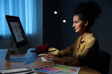 Photo of Designer working on computer indoors at night