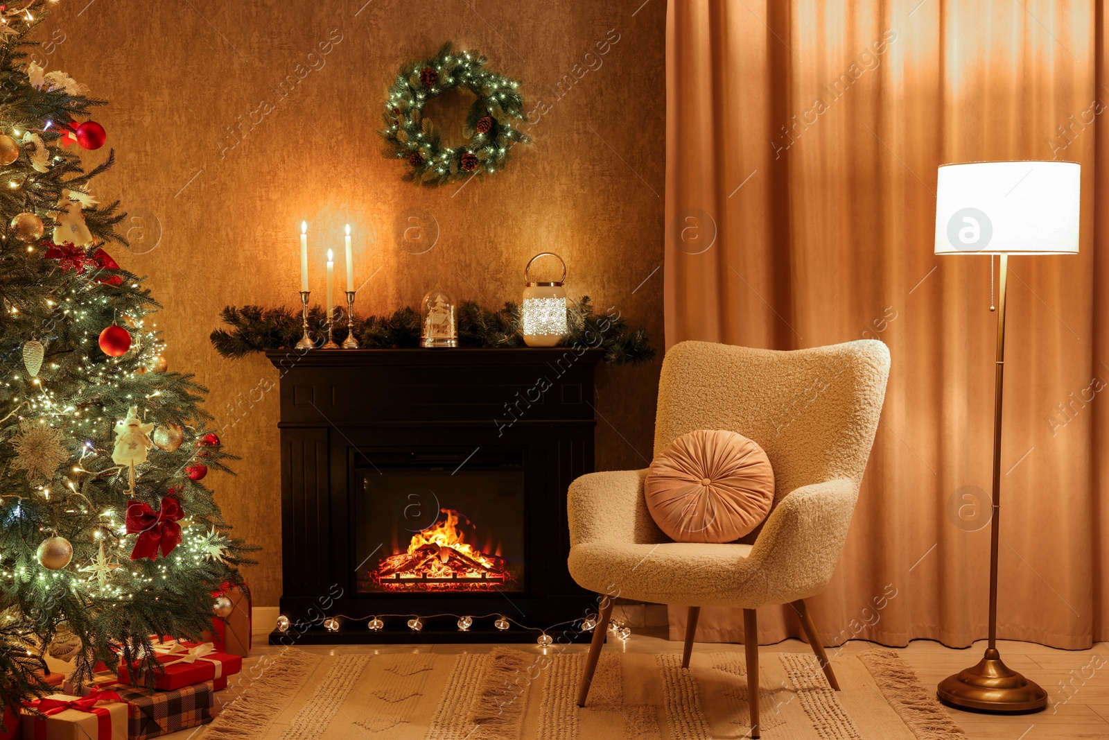 Photo of Fireplace, armchair, Christmas tree and festive decor in cozy room