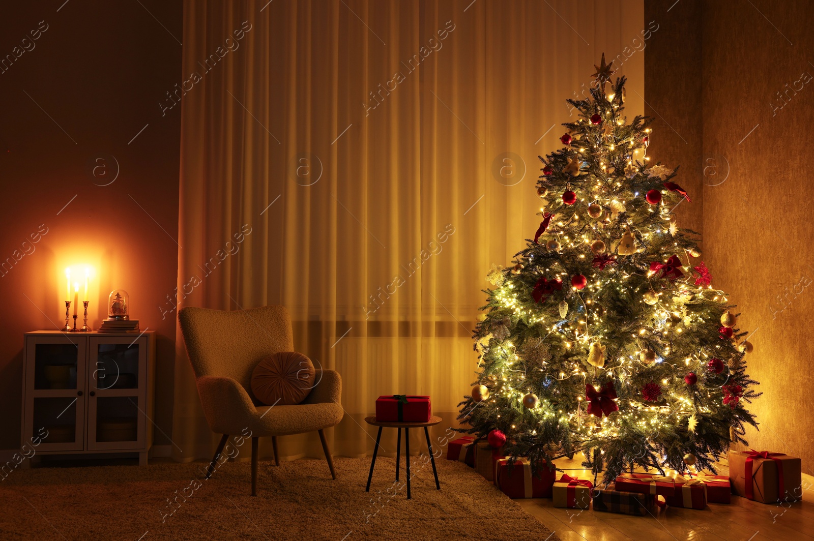 Photo of Cozy room with beautiful Christmas tree, armchair and lamp. Interior design for holiday