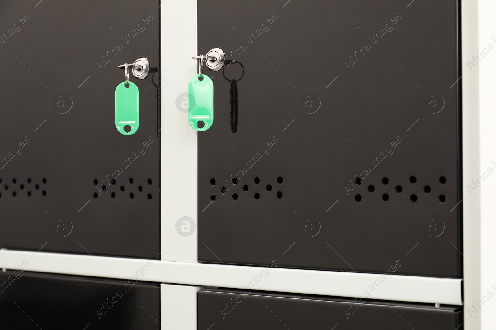 Photo of Modern lockers with bright keys, closeup view