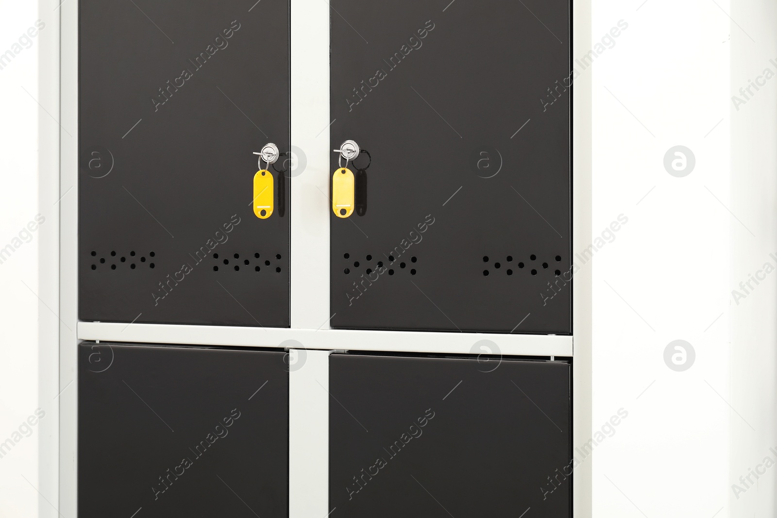 Photo of Modern lockers with bright keys indoors, closeup