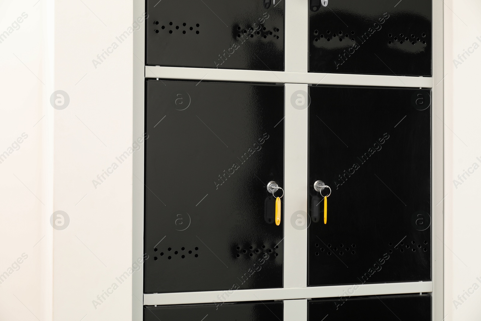 Photo of Modern lockers with bright keys indoors, closeup