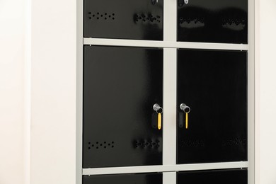 Modern lockers with bright keys indoors, closeup