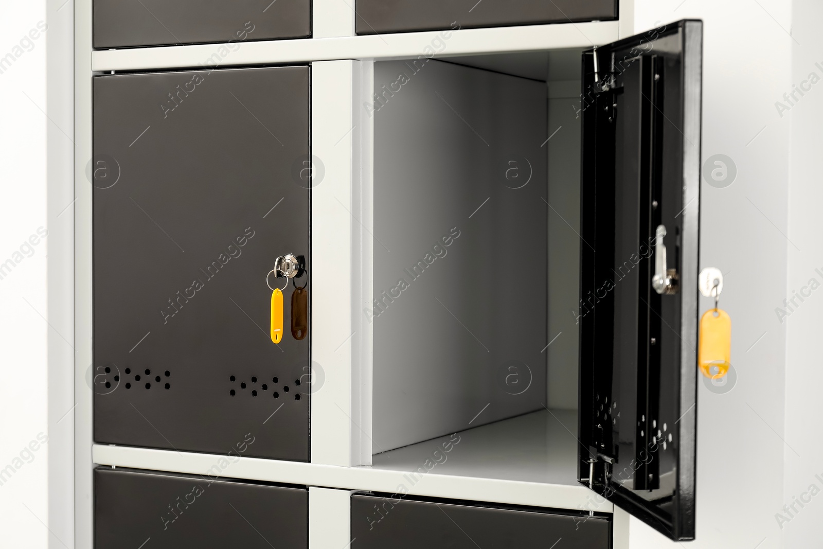 Photo of Modern lockers with bright keys indoors, closeup