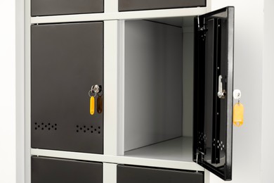 Photo of Modern lockers with bright keys indoors, closeup