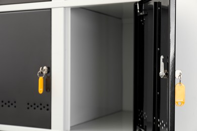 Modern lockers with bright keys indoors, closeup