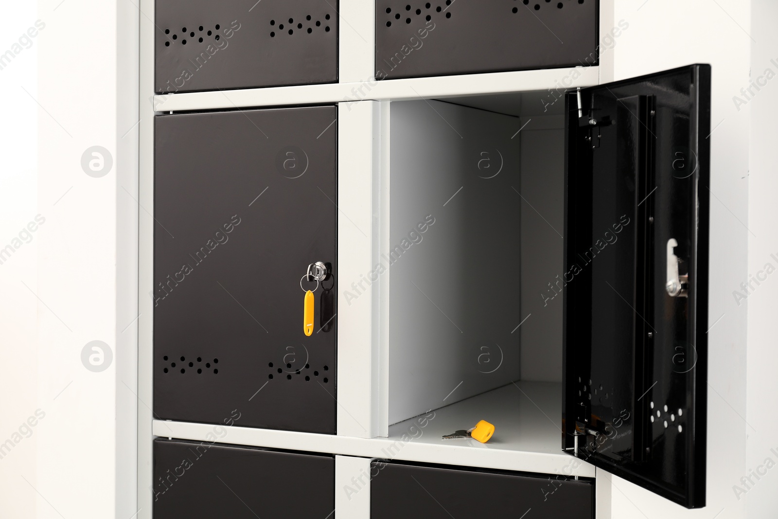 Photo of Modern lockers with bright keys indoors, closeup