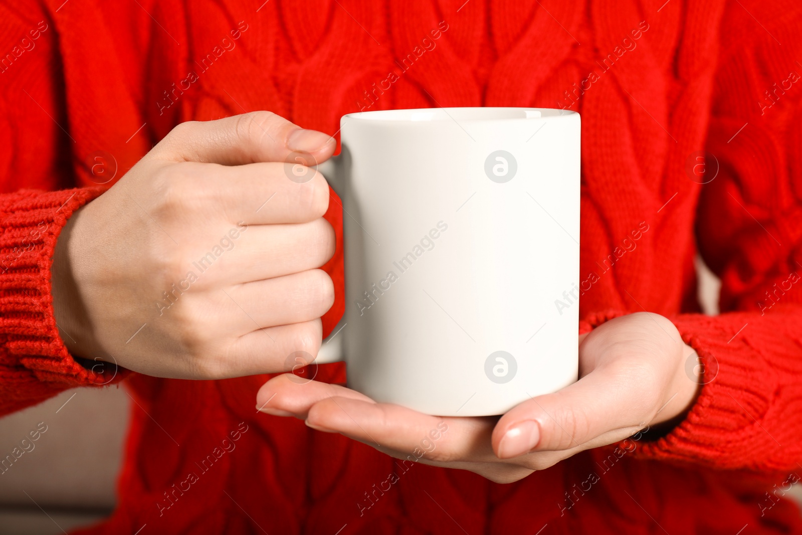 Photo of Woman holding blank white ceramic mug, closeup. Mockup for design