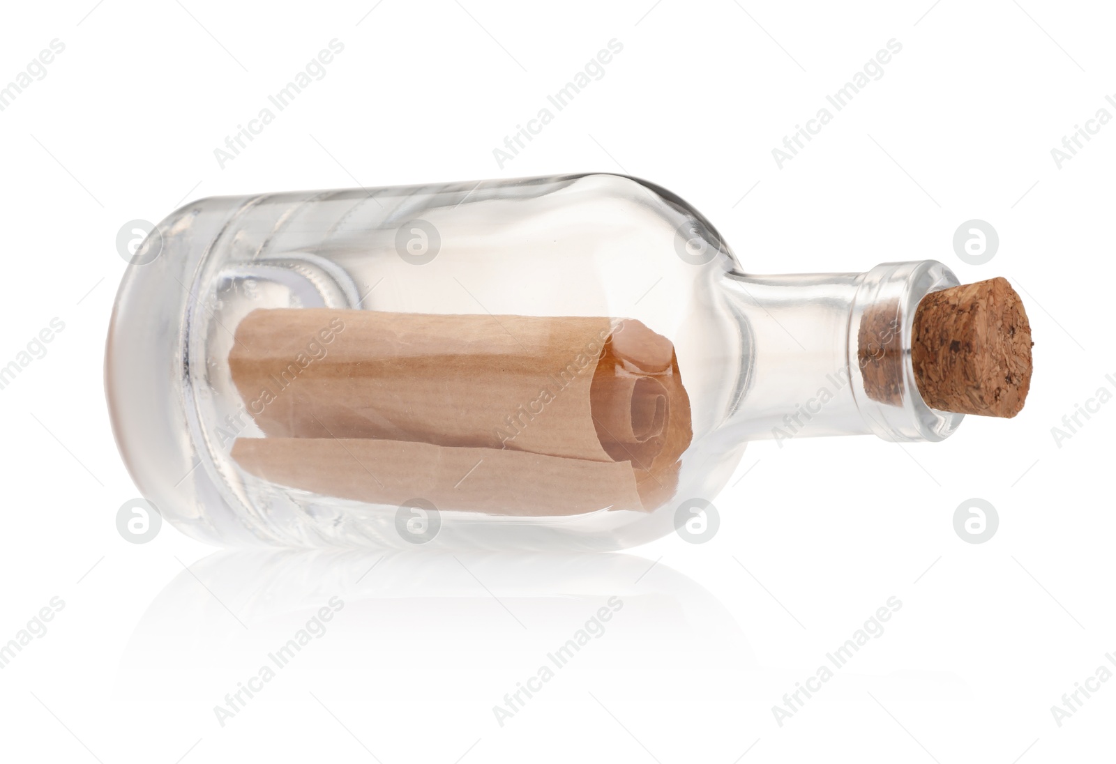 Photo of Corked glass bottle with rolled letter isolated on white