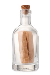 Photo of Corked glass bottle with rolled letter isolated on white