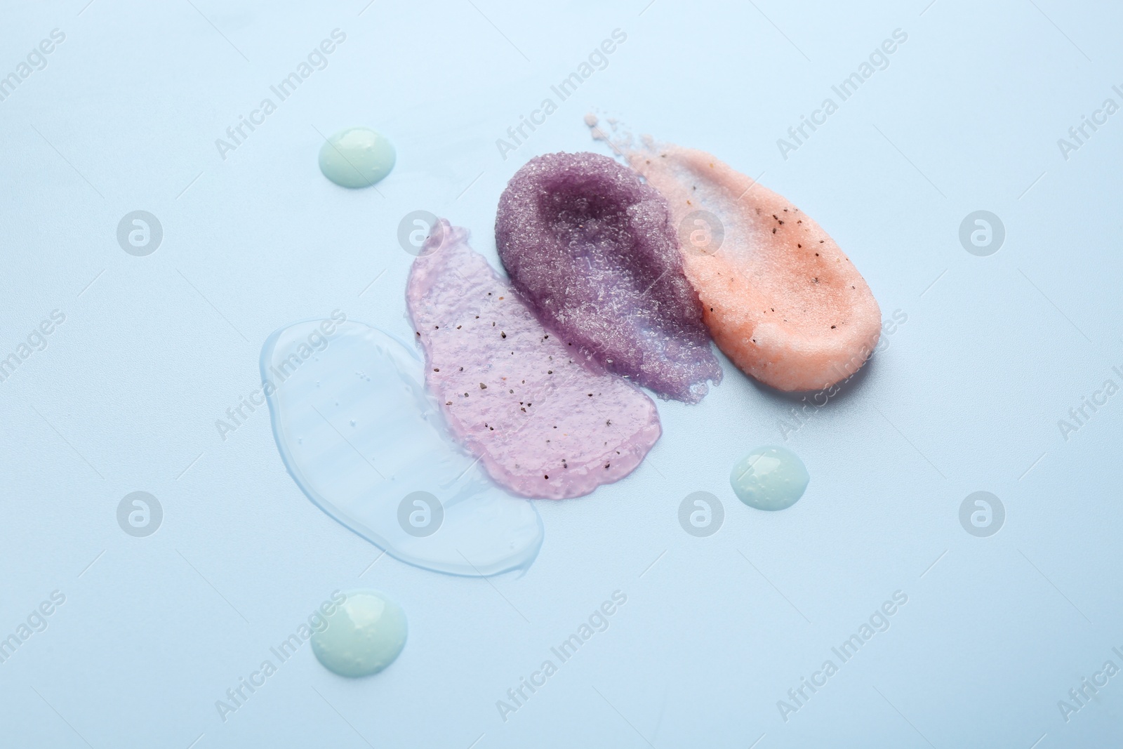 Photo of Samples of cosmetic products on light blue background. Skin care