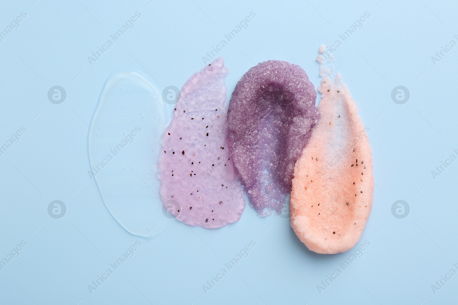 Photo of Samples of cosmetic products on light blue background, top view. Skin care