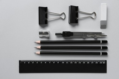 Photo of Flat lay composition with ruler and other stationery on light grey background