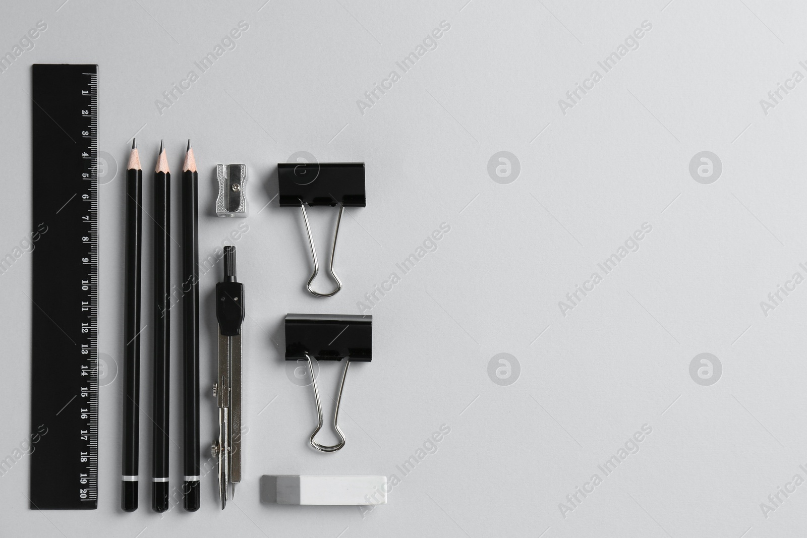 Photo of Flat lay composition with ruler and other stationery on light grey background, space for text