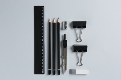 Photo of Flat lay composition with ruler and other stationery on light grey background