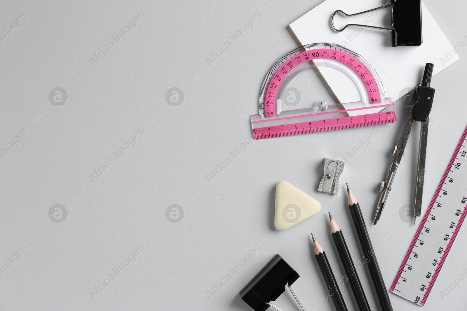 Photo of Flat lay composition with ruler and other stationery on light grey background, space for text