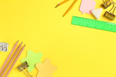 Photo of Flat lay composition with ruler and other stationery on yellow background, space for text