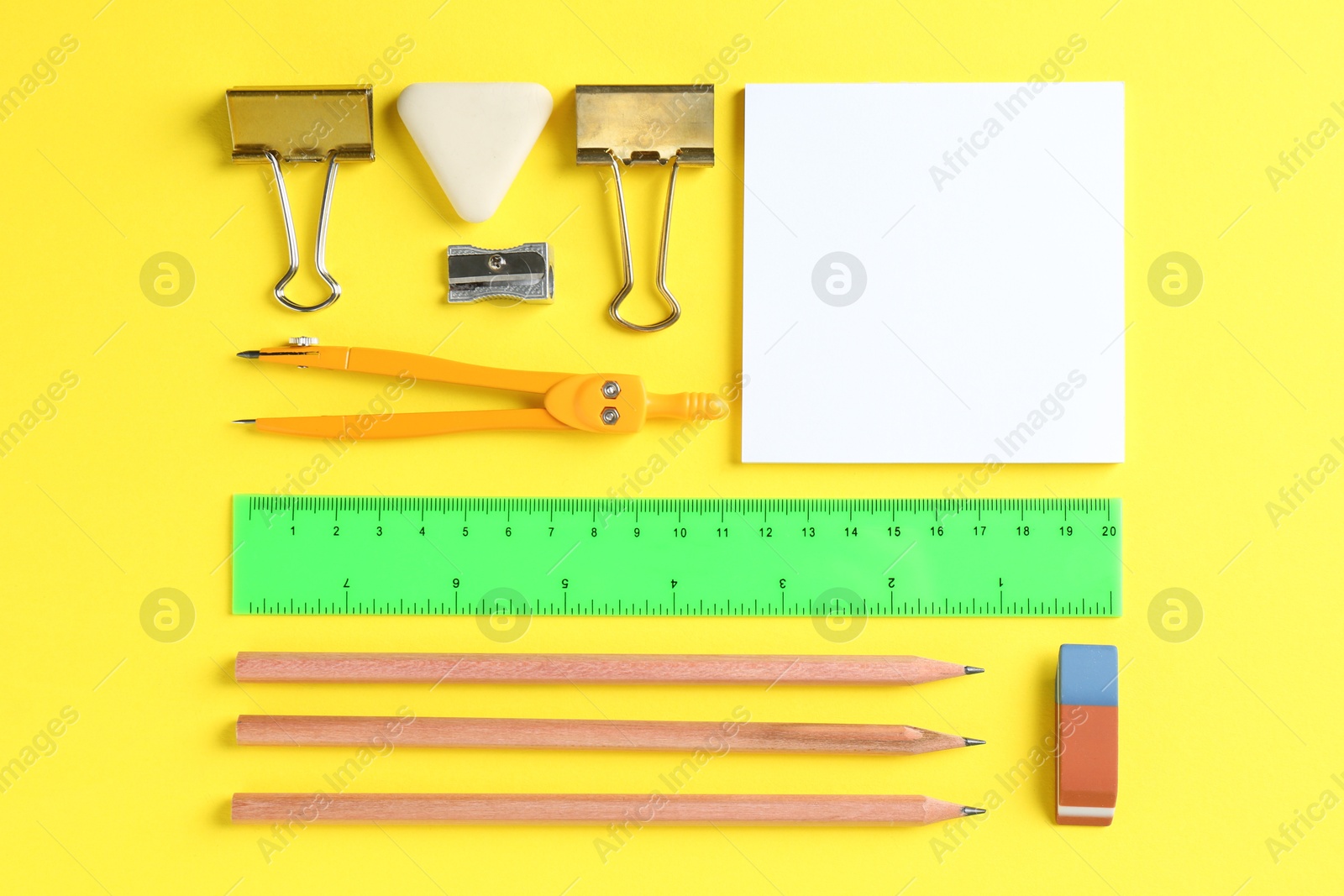 Photo of Flat lay composition with ruler and other stationery on yellow background