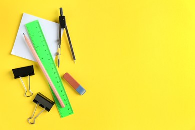 Photo of Flat lay composition with ruler and other stationery on yellow background, space for text