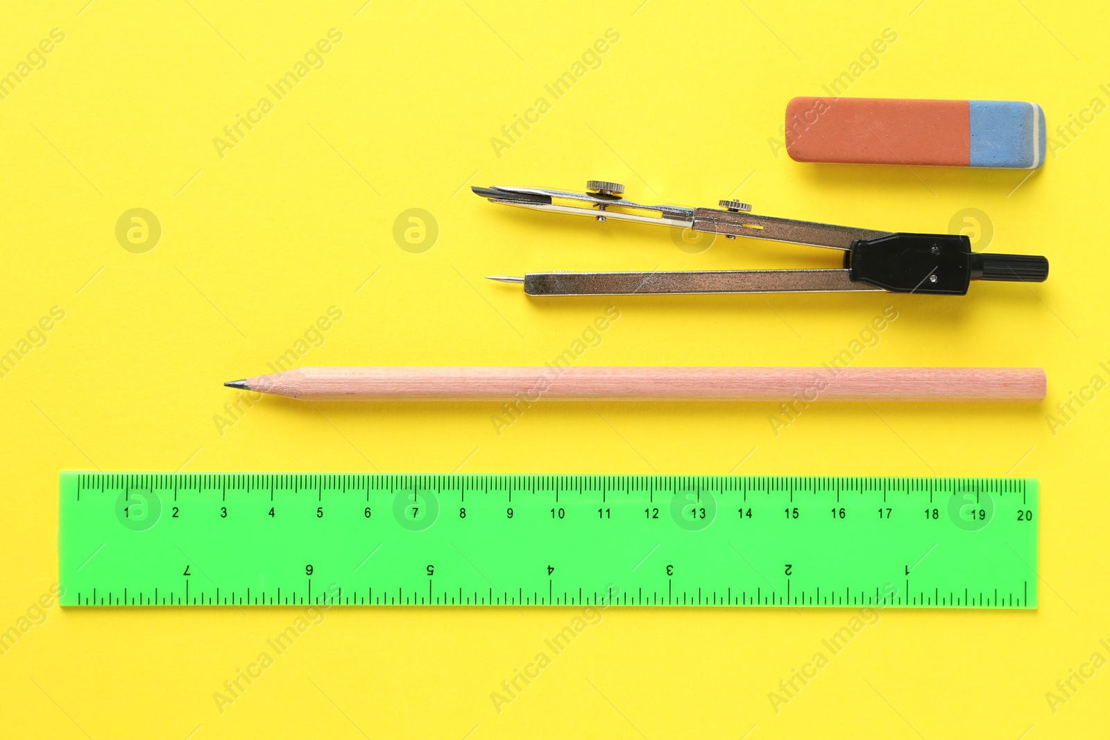 Photo of Flat lay composition with ruler and other stationery on yellow background