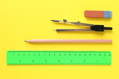 Photo of Flat lay composition with ruler and other stationery on yellow background