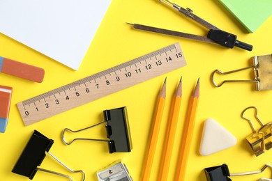 Photo of Flat lay composition with ruler and other stationery on yellow background