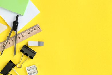 Photo of Flat lay composition with ruler and other stationery on yellow background, space for text