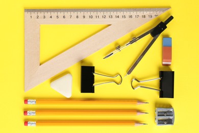 Photo of Flat lay composition with ruler and other stationery on yellow background