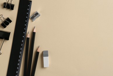 Photo of Flat lay composition with ruler and other stationery on beige background, space for text