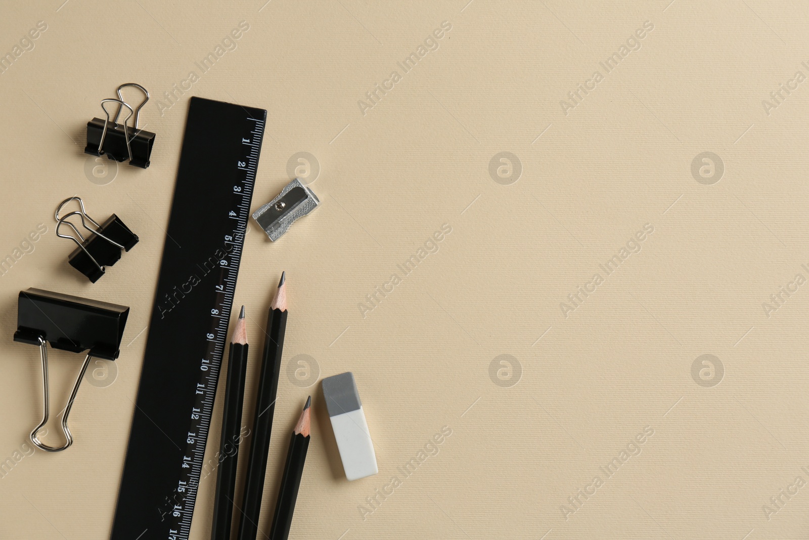 Photo of Flat lay composition with ruler and other stationery on beige background, space for text