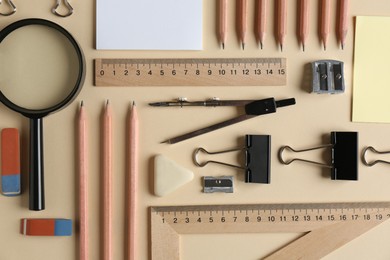 Photo of Flat lay composition with ruler and other stationery on beige background