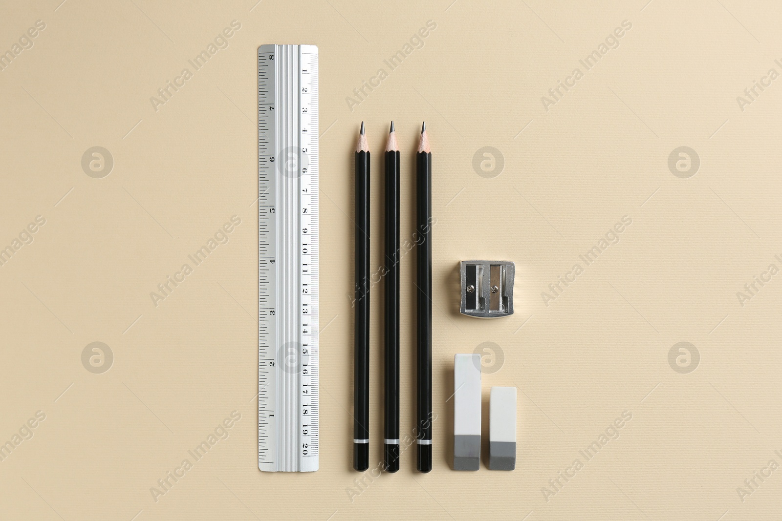 Photo of Flat lay composition with ruler and other stationery on beige background