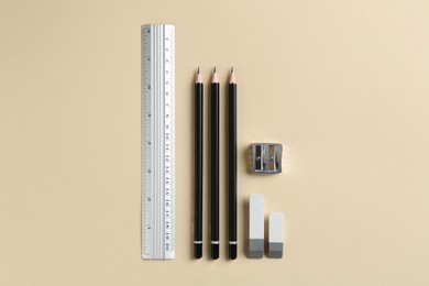 Photo of Flat lay composition with ruler and other stationery on beige background