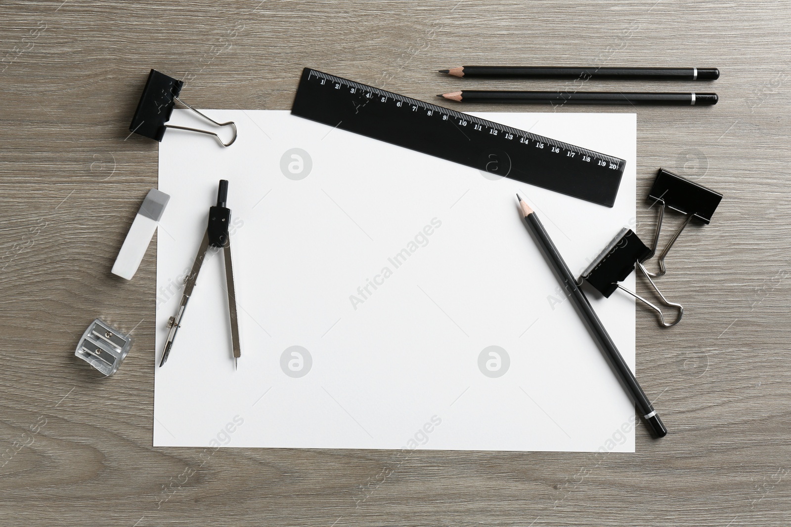 Photo of Flat lay composition with ruler and other stationery on wooden table, space for text